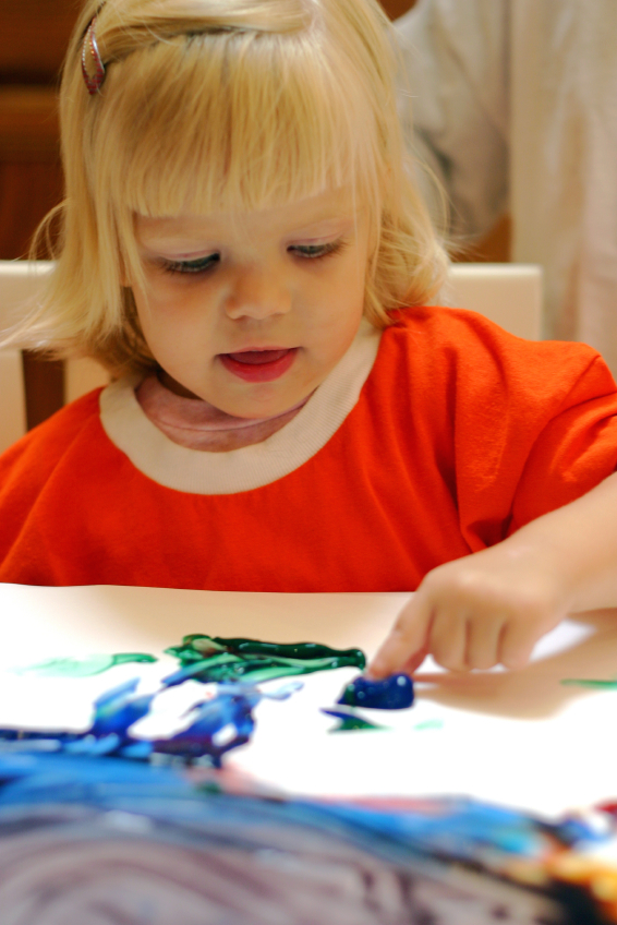 little girl finger painting